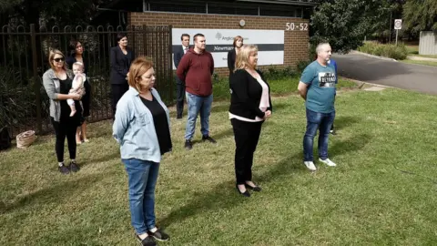 Getty Images Relatives of residents at Newmarch House stand socially distanced