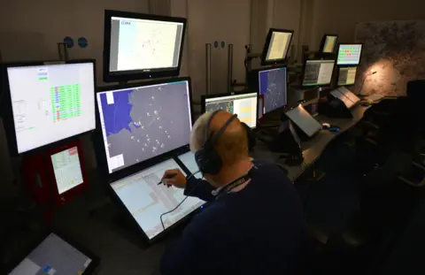 Getty Images Air traffic controllers at work in Manchester Airport