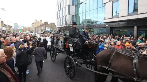 Liam McBurney/PA Media The funeral procession of Shane MacGowan makes its way through the streets of Dublin