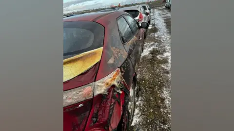 A red car badly burnt