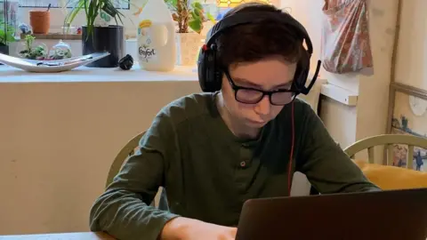 Family Photo Joshua doing his schoolwork