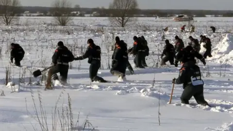 EPA Emergency services work at the scene of the crash