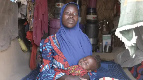 Ayo Bello/ BBC Hawa Goni and her daughter Amina