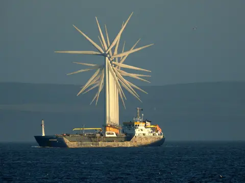 Tom Collins Sea wind turbines seen in a line