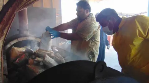 Getty Images Police incinerate the packets of cocaine in Majuro