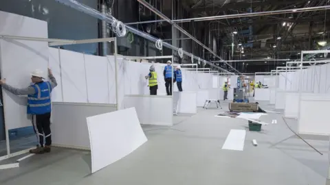 Getty Images Workers building the interior of the new temporary NHS Louisa Jordan Hospital at the SEC event centre on April 07, 2020 in Glasgow, Scotland.