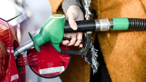 Getty Images Driver fills car with petrol