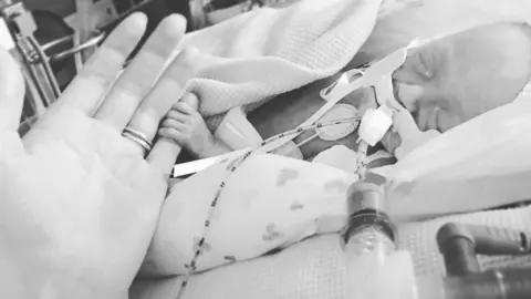 Laura Watson Arlo Watson gripping his mother's little finger