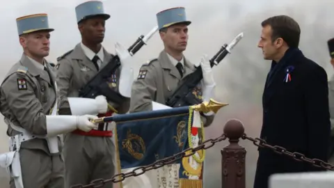 Getty Images French President Emmanuel Macron reviews a military honour guard as he attends a ceremony in tribute to the French soldiers killed in August 1914 during border battles, at the monument in Morhange, eastern France, on November 5, 2018