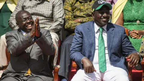 Getty Images Kenya's Deputy President, William Ruto (R) sits next to his running mate Rigathi Gachagua, at the Deputy's official residence in Karen, Nairobi, on May 15, 2022