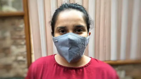 Activist and aid worker Srabanti Huda wearing a face mask