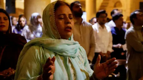 Reuters A woman attends the Easter Sunday service at the Holy Trinity Cathedral Church of Pakistan, in Karachi