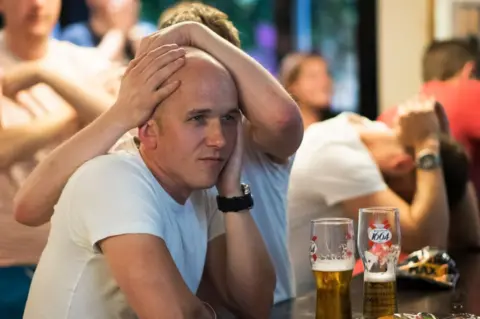 Getty Images Fans in the The Lord Stamford pub in Manchester
