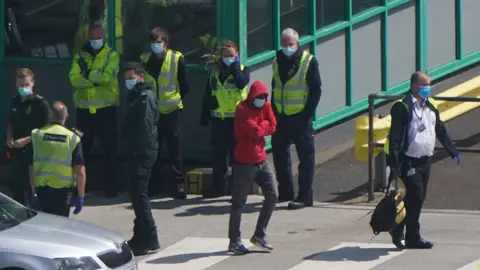 PA Media Migrants arriving at Dover
