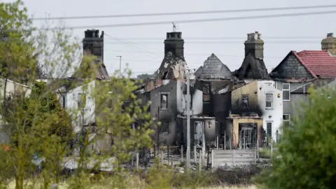 Reuters Burned out houses in Wennington