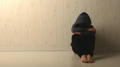 Getty Images child hiding face