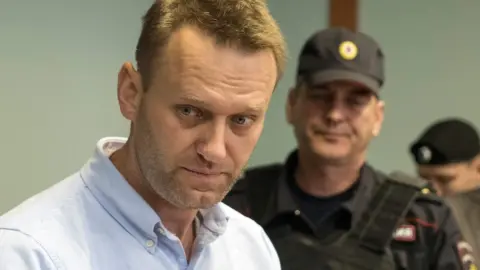 AFP Russian jailed opposition leader Alexei Navalny arrives for a hearing at a court in Moscow, 16 June 2017