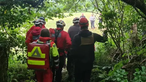 Cornwall Air Ambulance  Emergency services take man to helicopter