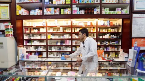 Getty Images Man working at a pharmacy in Iran