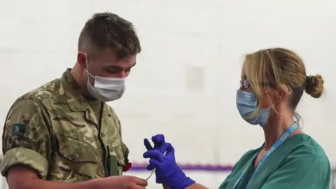 PA Media Soldier and NHS worker