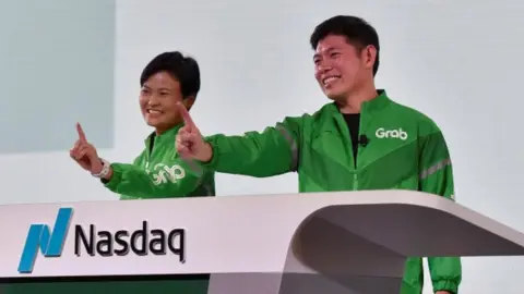 Reuters Grab CEO Anthony Tan and co-founder Tan Hooi Ling at the Grab Bell Ringing Ceremony at a hotel in Singapore.