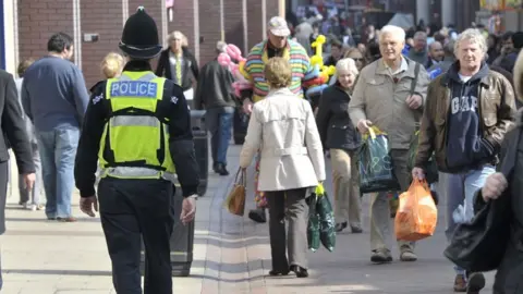 Suffolk Police  A police officer walking down the street