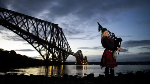 PA Piper Louise Marshall at dawn alongside the Forth Bridge