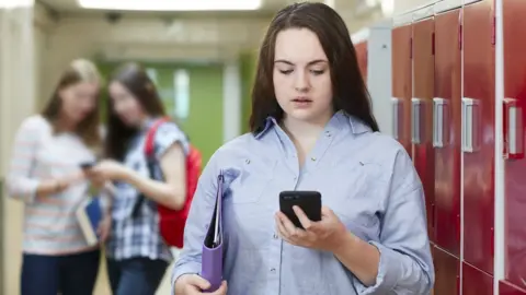 Getty Images Student looking at mobile phone