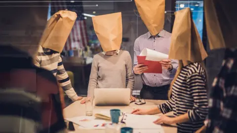 Getty Images Workers with paper bags over their heads