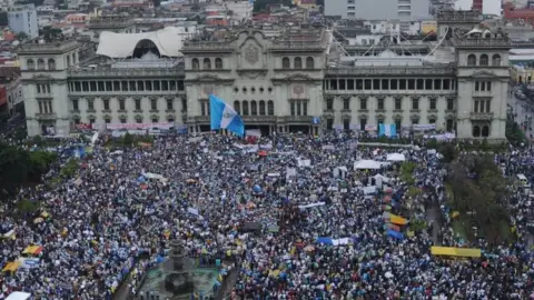 AFP Aerial view taken during a protest to demand the resignation of Guatemalan President Otto Perez as a corruption scandal rocks the government, at Constitution Square in front of the Culture Palace in Guatemala City on May 16, 2015.