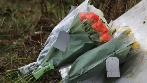 PA Media Flowers from members of the public left near Great Chart Golf and Leisure near Ashford in Kent