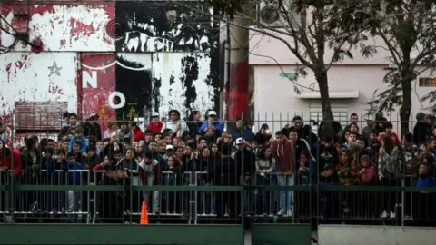 Reuters Crowds outside the hotel where Lionel Messi's wedding takes place in Rosario, Argentina. Photo: 30 June 2017