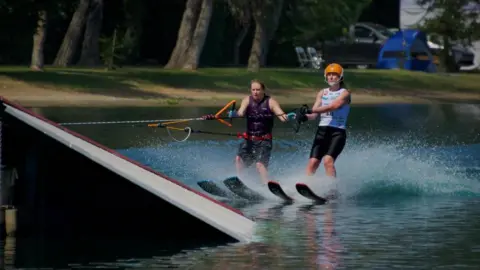 John Lipscomb Jill Williams about to jump a ramp with her guide at the World Disabled Water Skiiing.