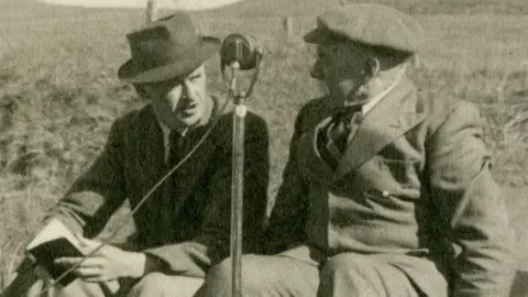 MNH Archive photo from the Manx Museum of two men with a microphone