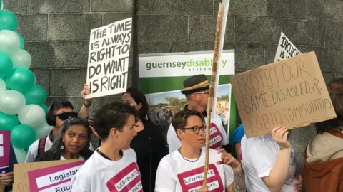 Protesters holding signs