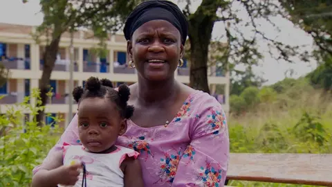 A woman holding her child