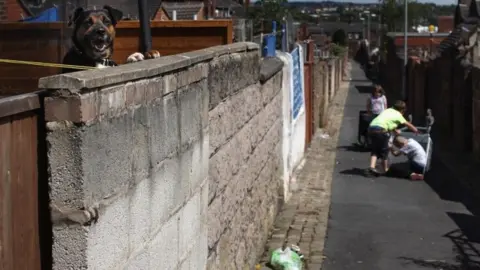 Getty Images Children playing in a back alley