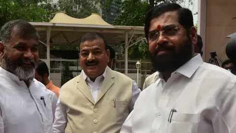 Getty Images Eknath Shinde (R) seen with other state lawmakers