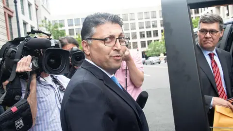 AFP/Getty US Assistant Attorney General Makan Delrahim walks to his car after a court ruled that the 85 billion USD merger between AT&T and Time Warner could go ahead in Washington, DC, on June 12, 2018