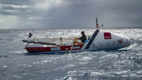 Row for Amy Andrew Osborne rowing on his boat