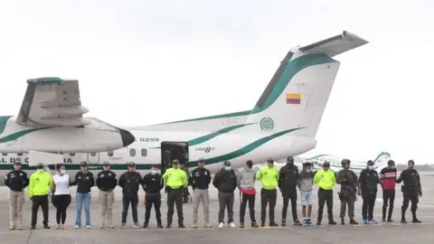 Getty Images Police showing off the detained suspects earlier this month