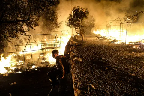 Byron Smith / Getty Images Fires rage at the Moria migrant camp on 9 September 2020, in Lesbos, Greece