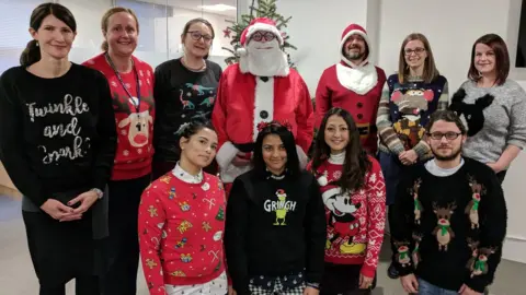 Royal College of Speech & Language Therapists  A group photo of Royal College of Speech & Language Therapists staff wearing Christmas jumpers