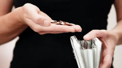 Getty Images Woman holding money