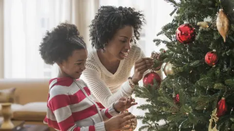 Getty Images Photo of a mother and daughter near a Christmas tree
