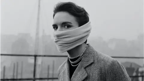 Getty Images woman wearing smog mask in 1953