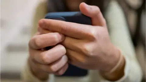 A woman uses a phone