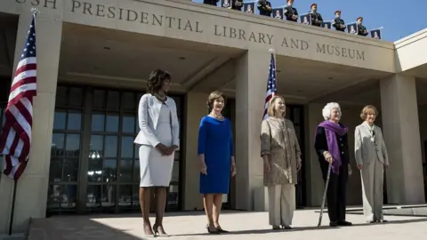 AFP US first lady Michelle Obama, stands with former first ladies Laura Bush, Hillary Clinton, Barbara Bush and Rosalynn Carter as they arrive for a dedication ceremony at the George W. Bush Library and Museum on the grounds of Southern Methodist University April 25, 2013