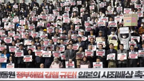 EPA Survivors of Japanese forced labour demonstrate with opposition party members in front of the National Assembly in Seoul, South Korea, 07 March 2023.