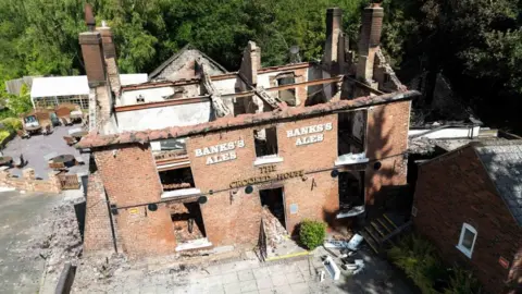 PA Media Crooked House pub